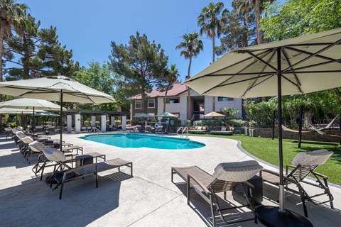 a swimming pool with umbrellas and chairs around it