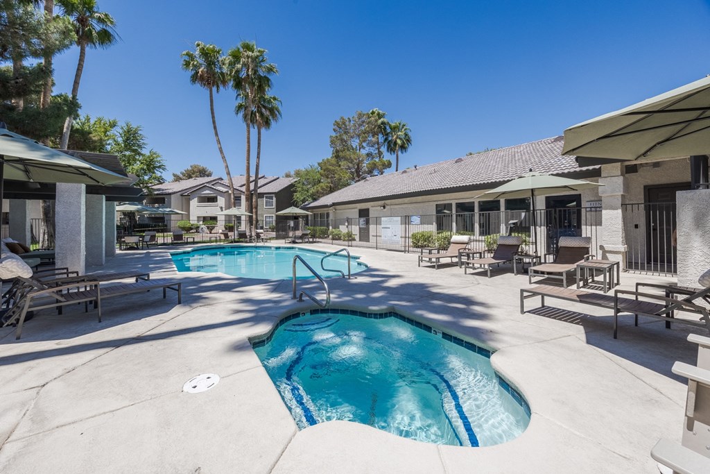 our resort style swimming pool is surrounded by our buildings and palm trees