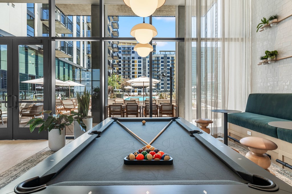 A pool table with a view of the city in the background.