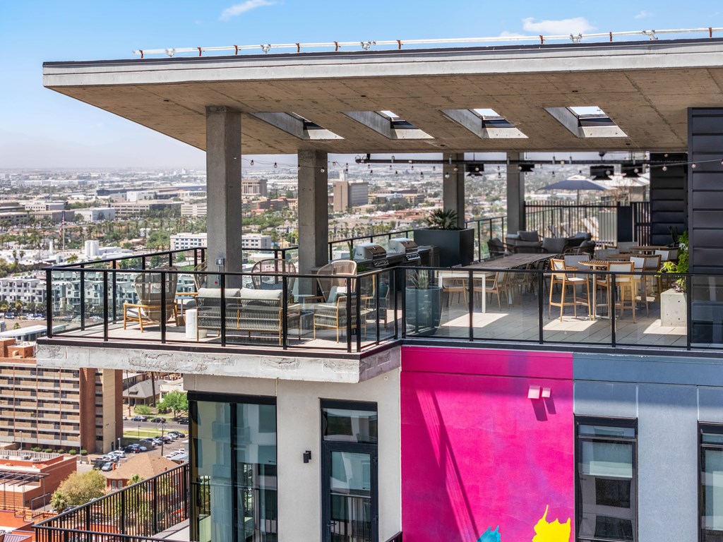 Exterior building with a balcony overlooking a cityscape.