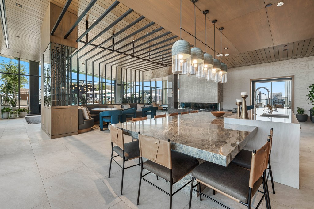 A modern dining room with a large table and chairs in the club room