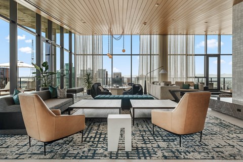 A modern living room with a large window overlooking the city.