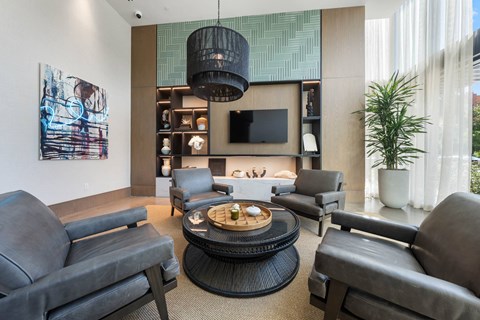 A modern lobby with a grey sofa and a black coffee table.