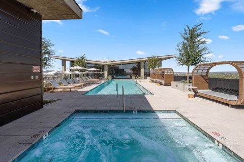 A large outdoor swimming pool with a slide.