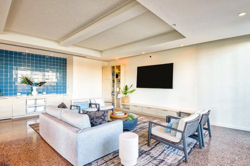 a living room with a couch and chairs and a television