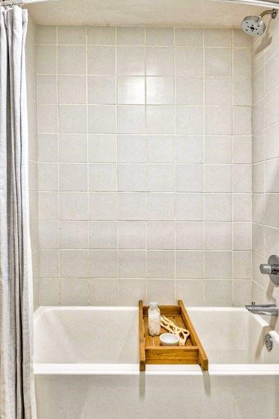 a bathroom with a bath tub and a wooden tray