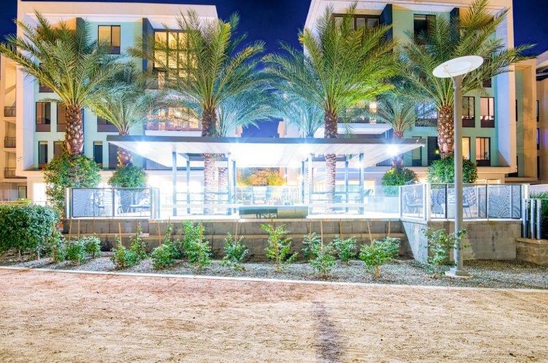 a building with palm trees in front of it