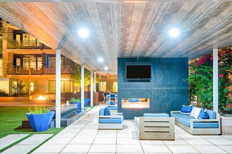 a patio with furniture and a television in a house