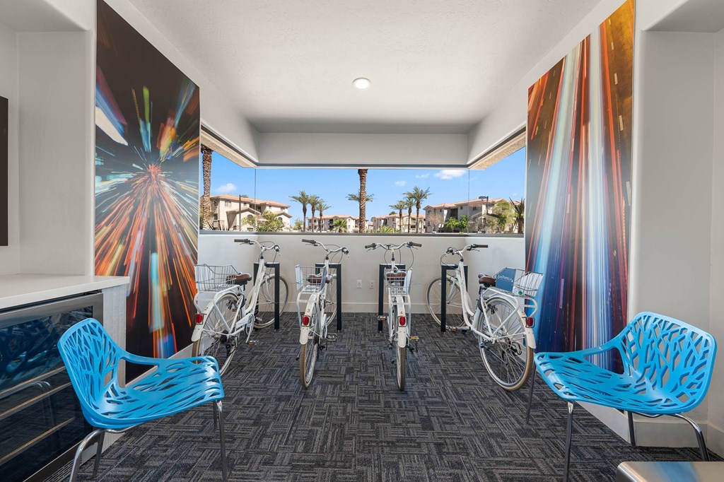 A room with a firework mural on the wall and bicycles parked in front of it.