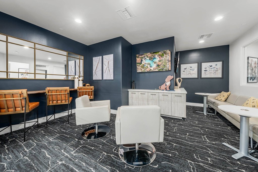 A room with a grey floor and white furniture.