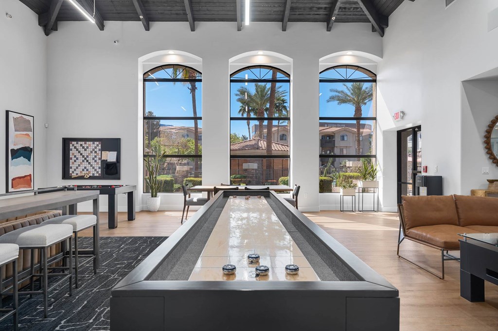 A billiard table is in the middle of a room with a pool table and a couch.