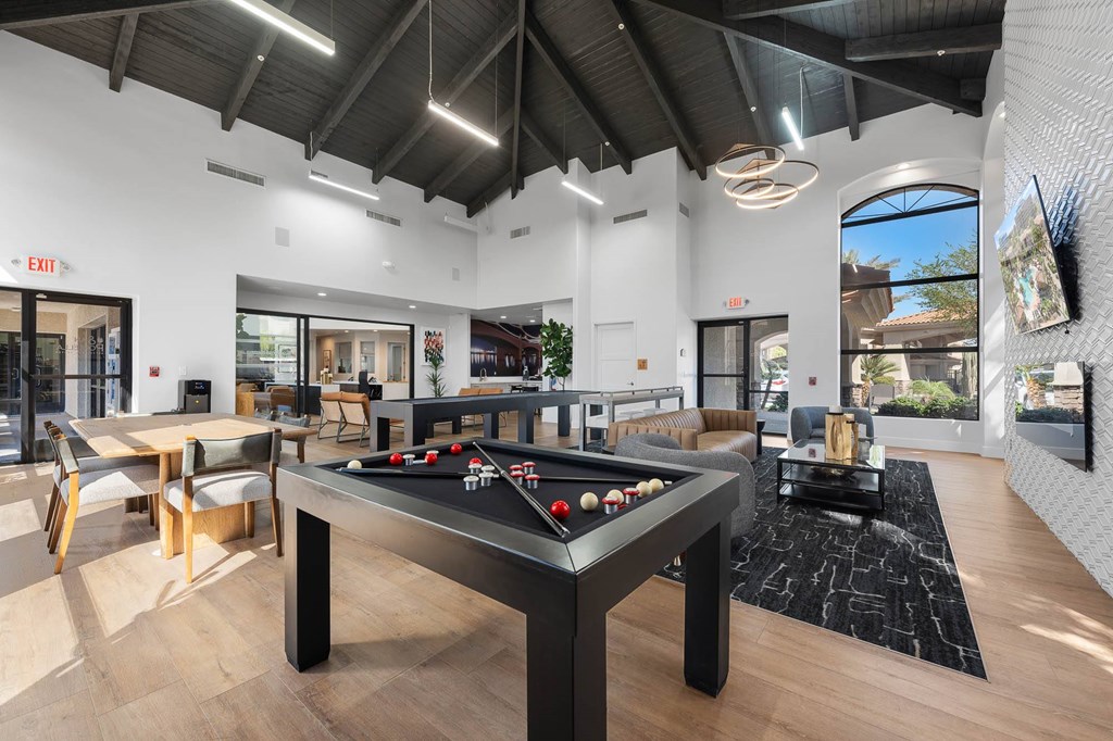 A room with a pool table and a foosball table.