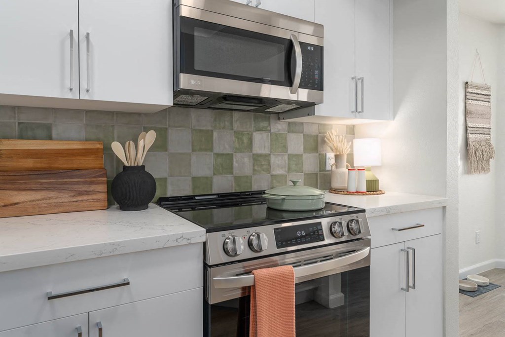 a kitchen with a stove and a microwave