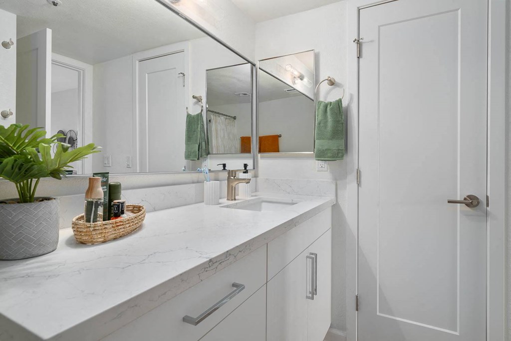 a white bathroom with a sink and a mirror