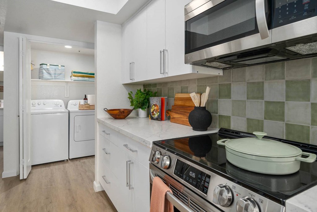 a kitchen with a stove top oven and a microwave