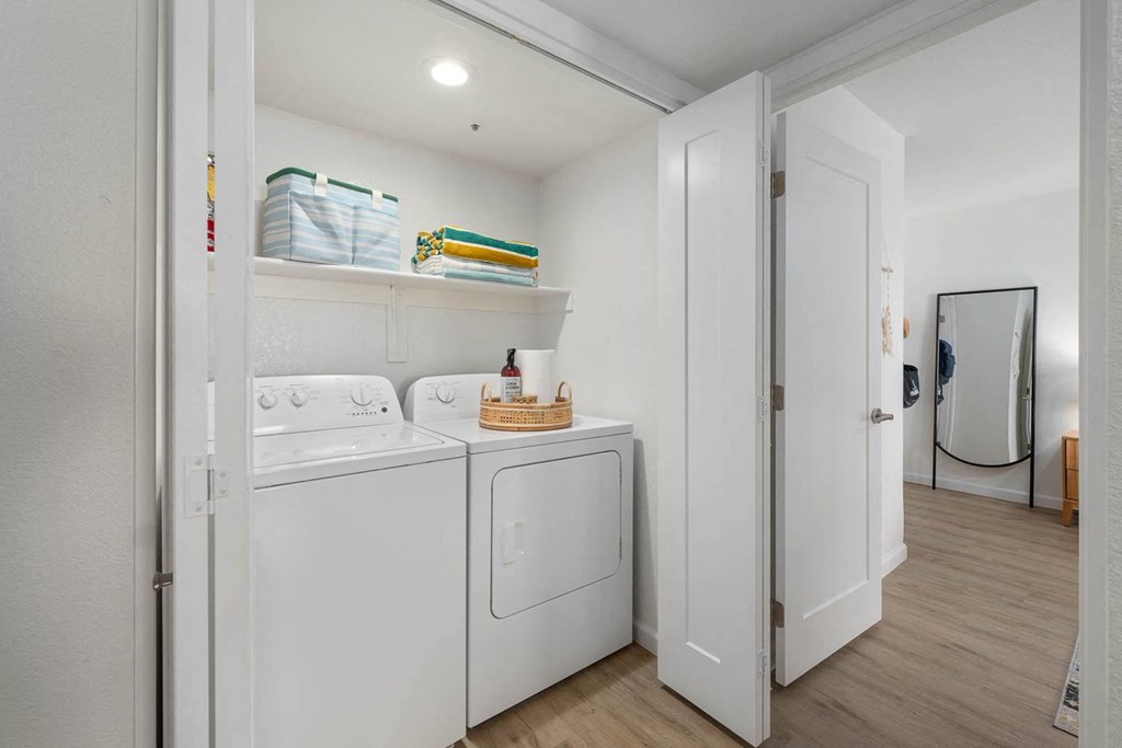 a white laundry room with a washer and dryer
