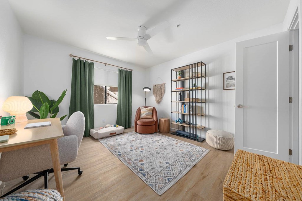 a living room with a desk and a door
