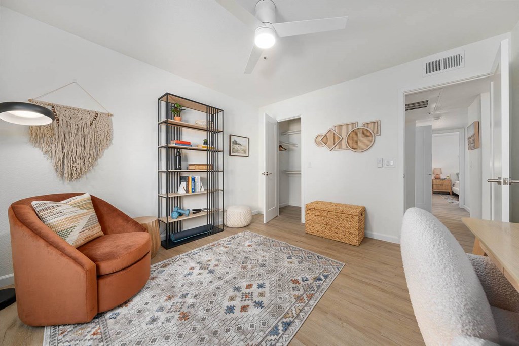 a living room with a couch and a chair and a door to a hallway