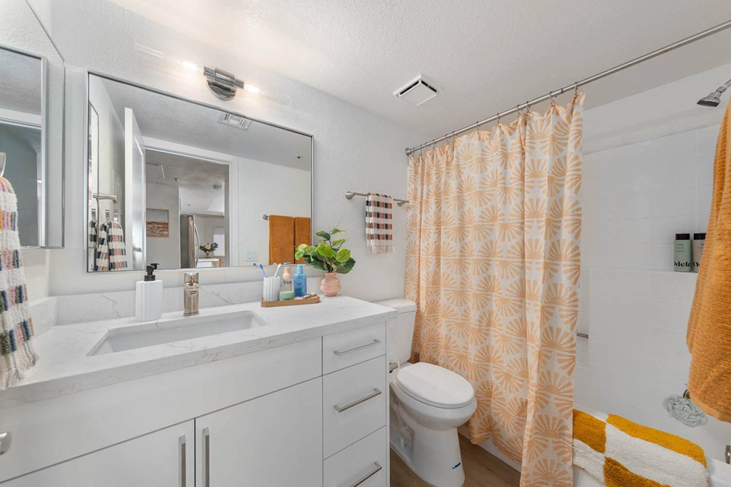 a bathroom with a shower and a sink and a toilet