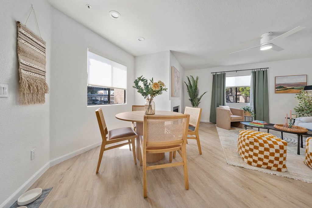 a dining room and living room with a table and chairs
