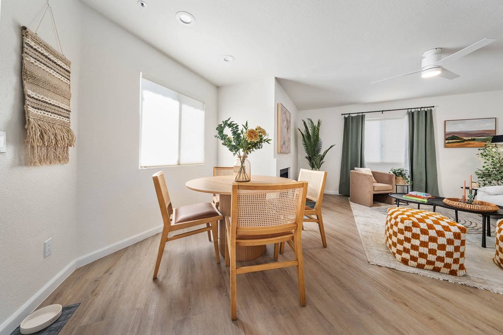 a dining room and living room with a table and chairs