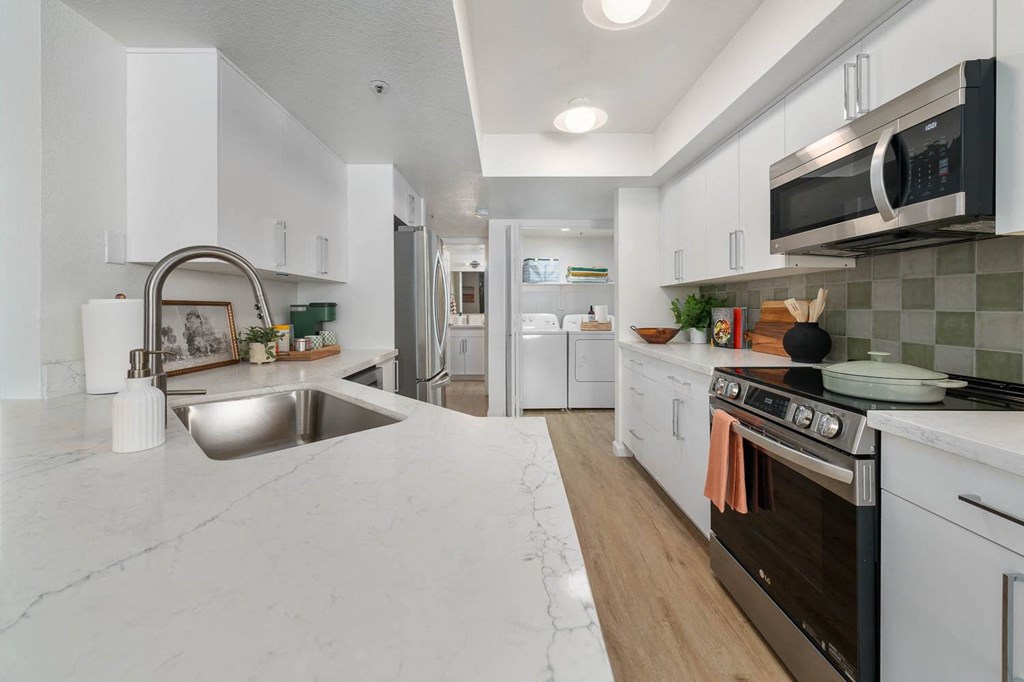 a kitchen with marble counter tops and a sink