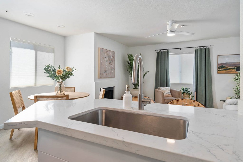 a kitchen with a sink and a dining room