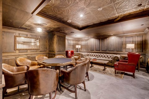 A room with a wooden ceiling and a table with chairs.