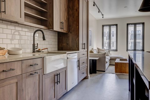 A kitchen with wooden cabinets and a white sink.