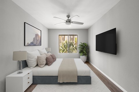 A bedroom with a bed, nightstand, and a painting on the wall.