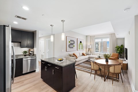 A modern kitchen with a dining table and chairs.
