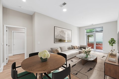 A modern living room with a wooden table and chairs.