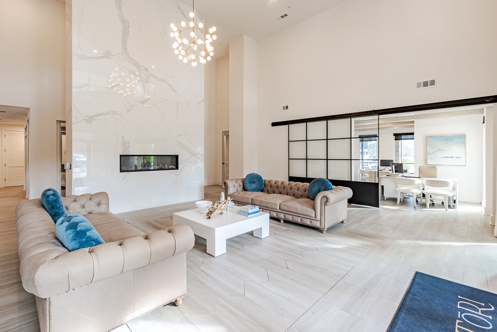 A modern living room with a large couch and a television.