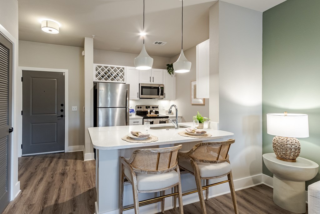 A kitchen with a table and chairs.