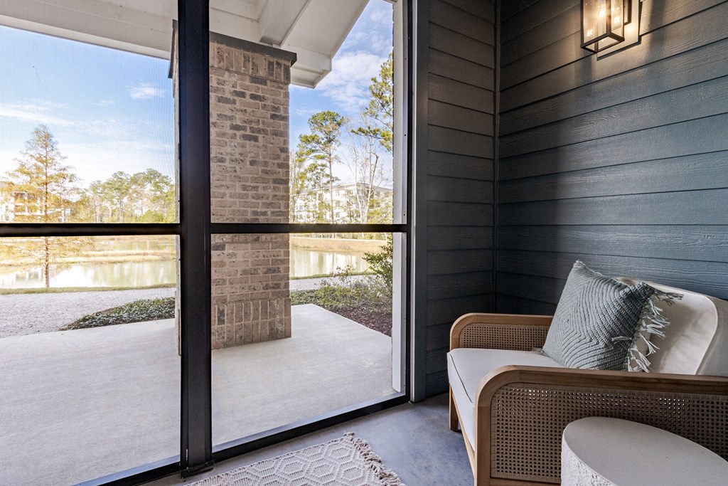 A patio with a couch and a pillow is shown.