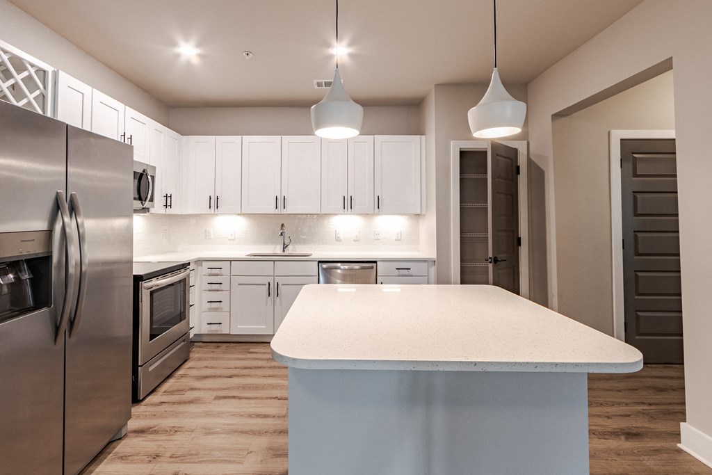 A modern kitchen with a large island in the center.