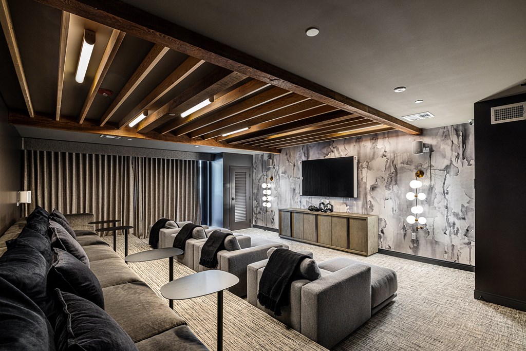 a large living room with couches and chairs and a television