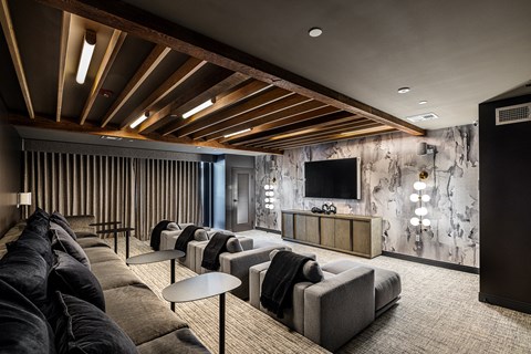 a large living room with couches and chairs and a television