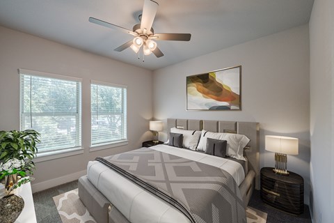 a bedroom with a large bed and a ceiling fan