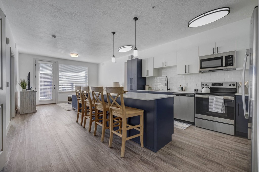 A modern kitchen with a dining table and chairs.