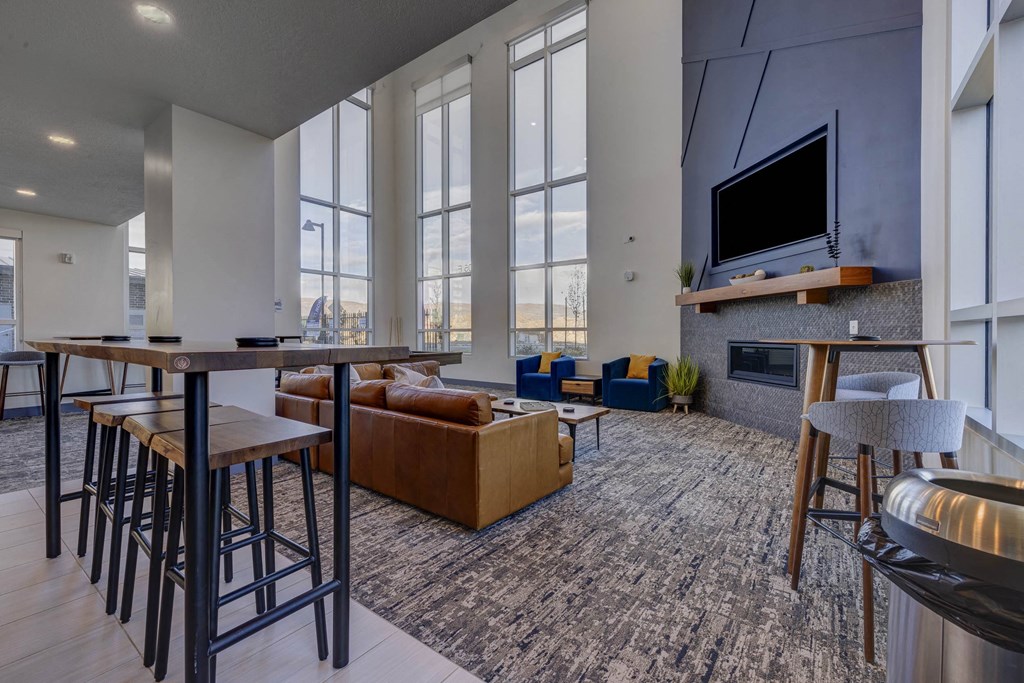 A modern living room with a bar area and a fireplace.