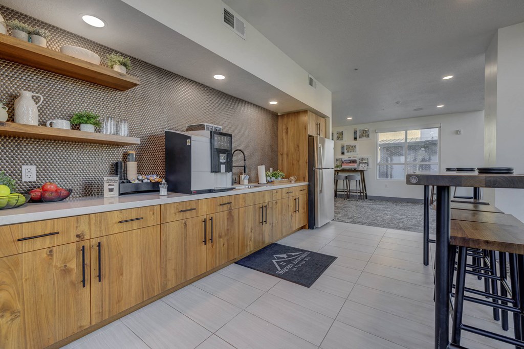 A kitchen with wooden cabinets and a black mat on the floor.