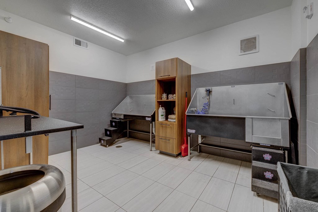 A kitchen with a stainless steel sink and a stove top oven.