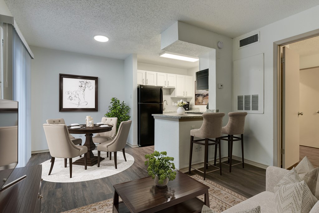 A modern kitchen with a dining table and chairs.