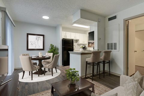 A modern kitchen with a dining table and chairs.