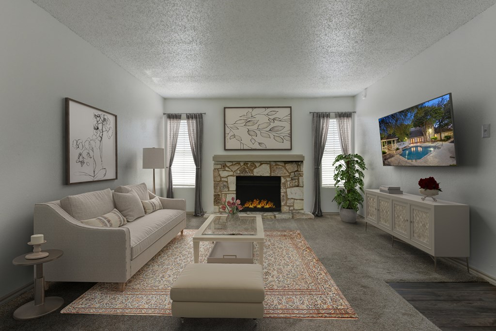 A living room with a fireplace and a television on the wall.