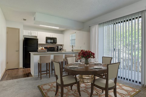 A dining room with a table set for four.