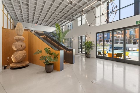 A modern interior with a wooden staircase and a plant in a pot.