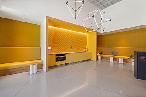 A modern room with a yellow wall and a black cabinet.