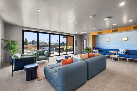 A living room with a blue couch and a green chair.